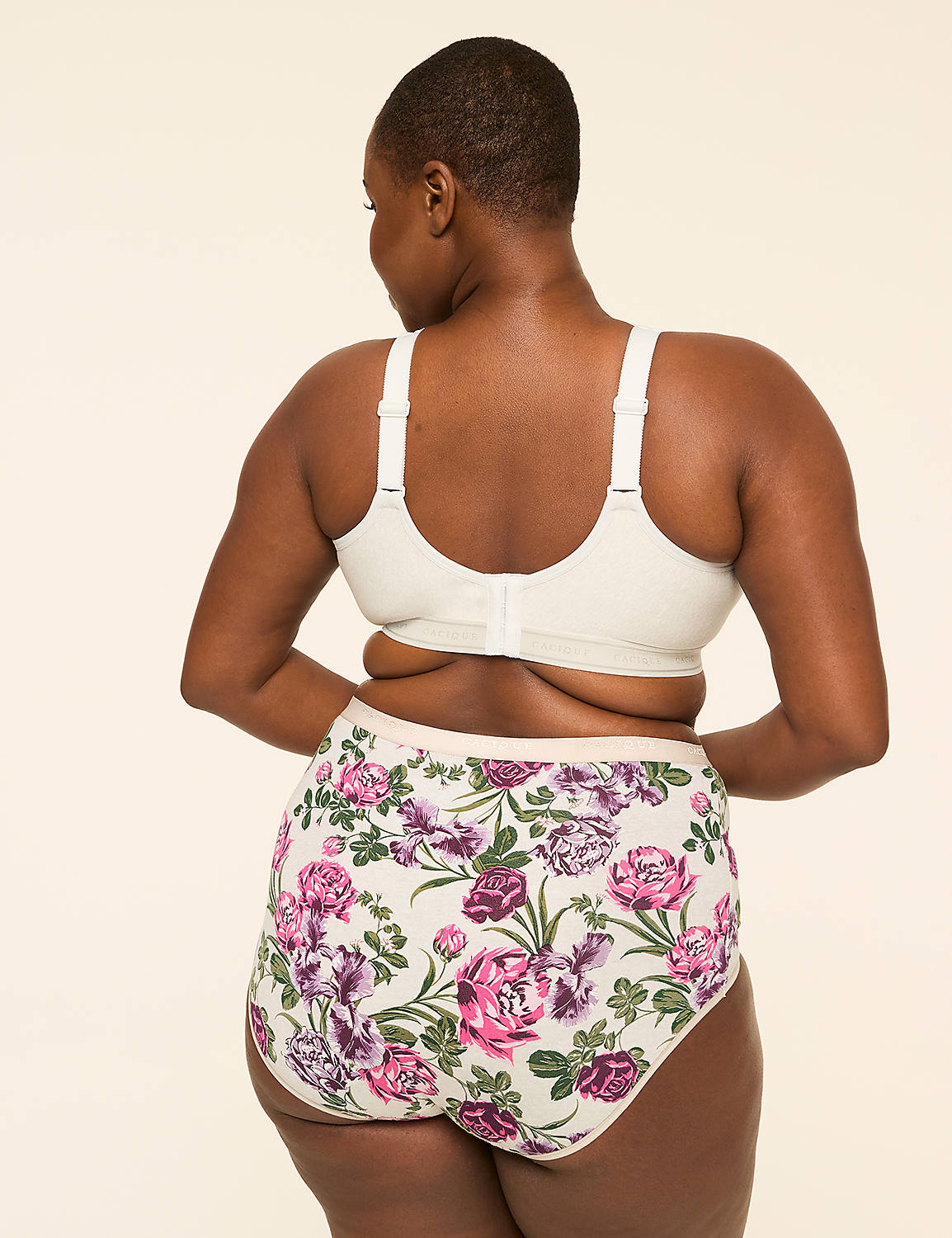 A woman from behind wears a white bra and floral-patterned underwear against a plain, light-colored background. Product Image 2