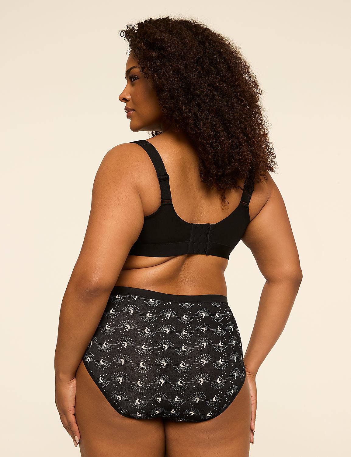A woman in a black bra and patterned underwear stands against a plain, light-colored background. Product Image 2