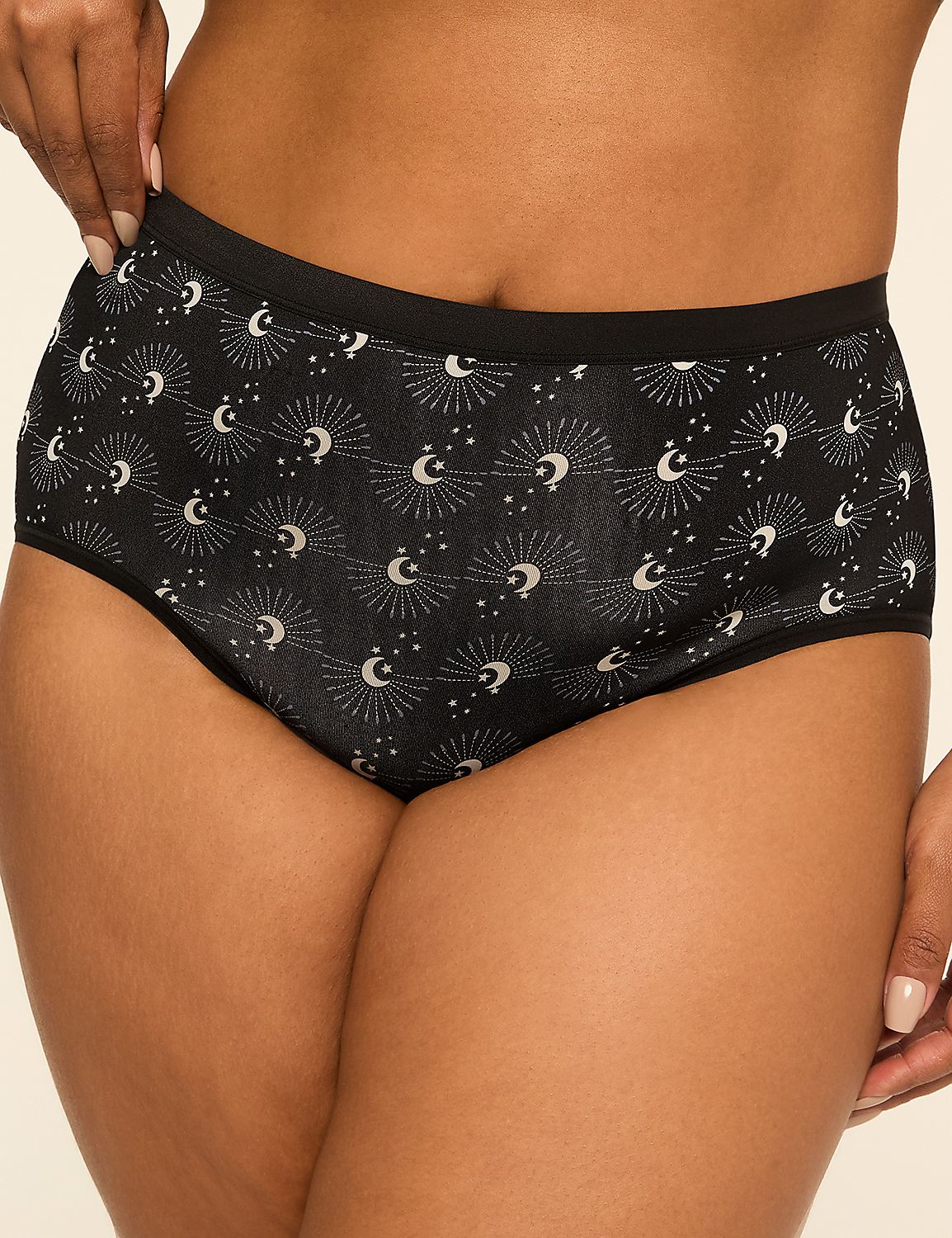 A person's lower torso is shown wearing black high-waisted underwear with a celestial pattern, against a plain, light-colored background. Product Image 1