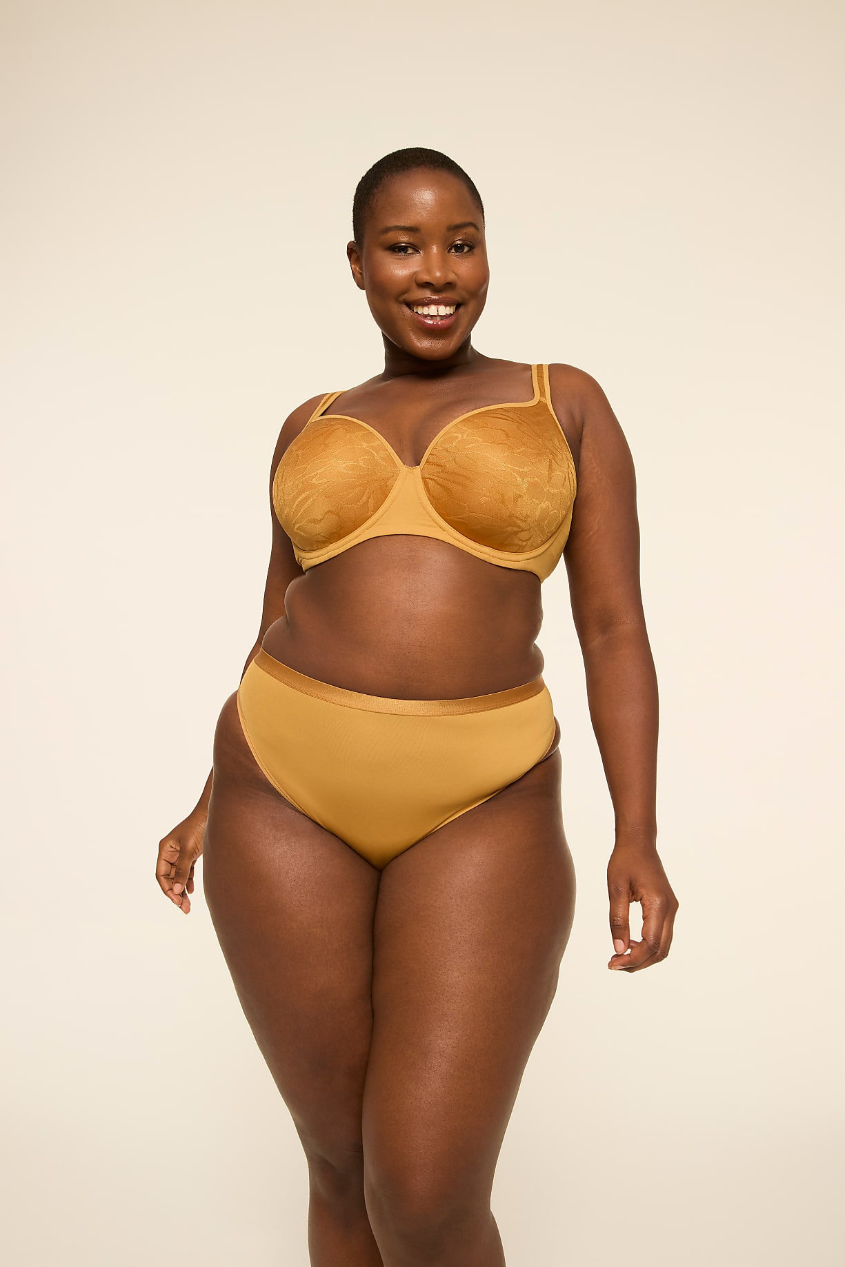 A smiling woman in a mustard-colored bra and underwear stands against a plain, light-colored background. Product Image 5