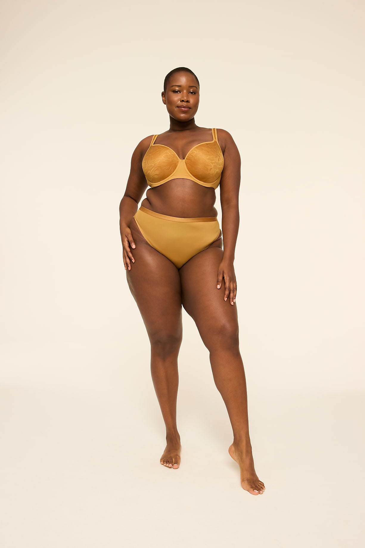 A woman in a gold bra and underwear stands against a plain, light-colored background. Product Image 6