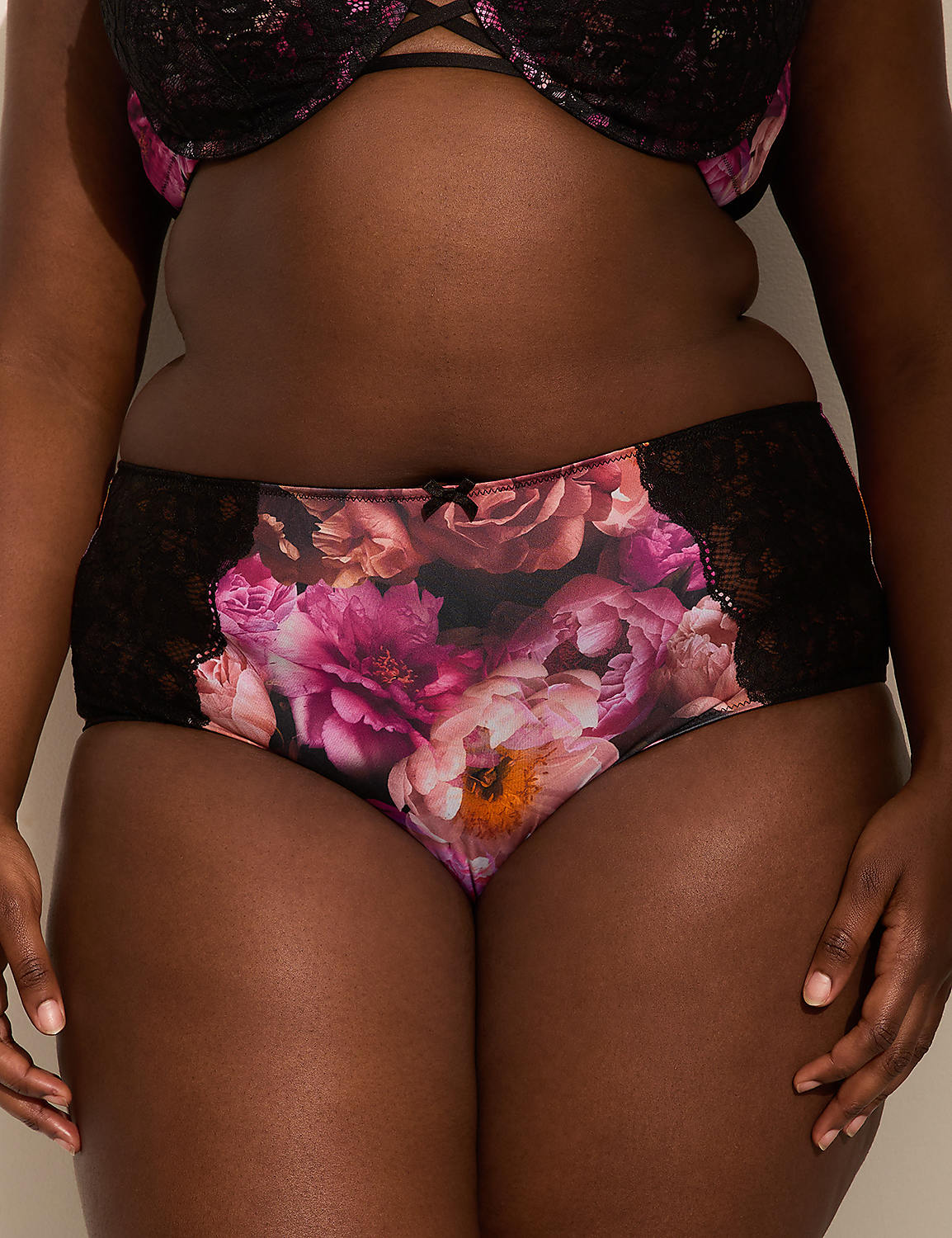 A person in floral-patterned underwear and a black lace bra stands against a plain background. Product Image 1