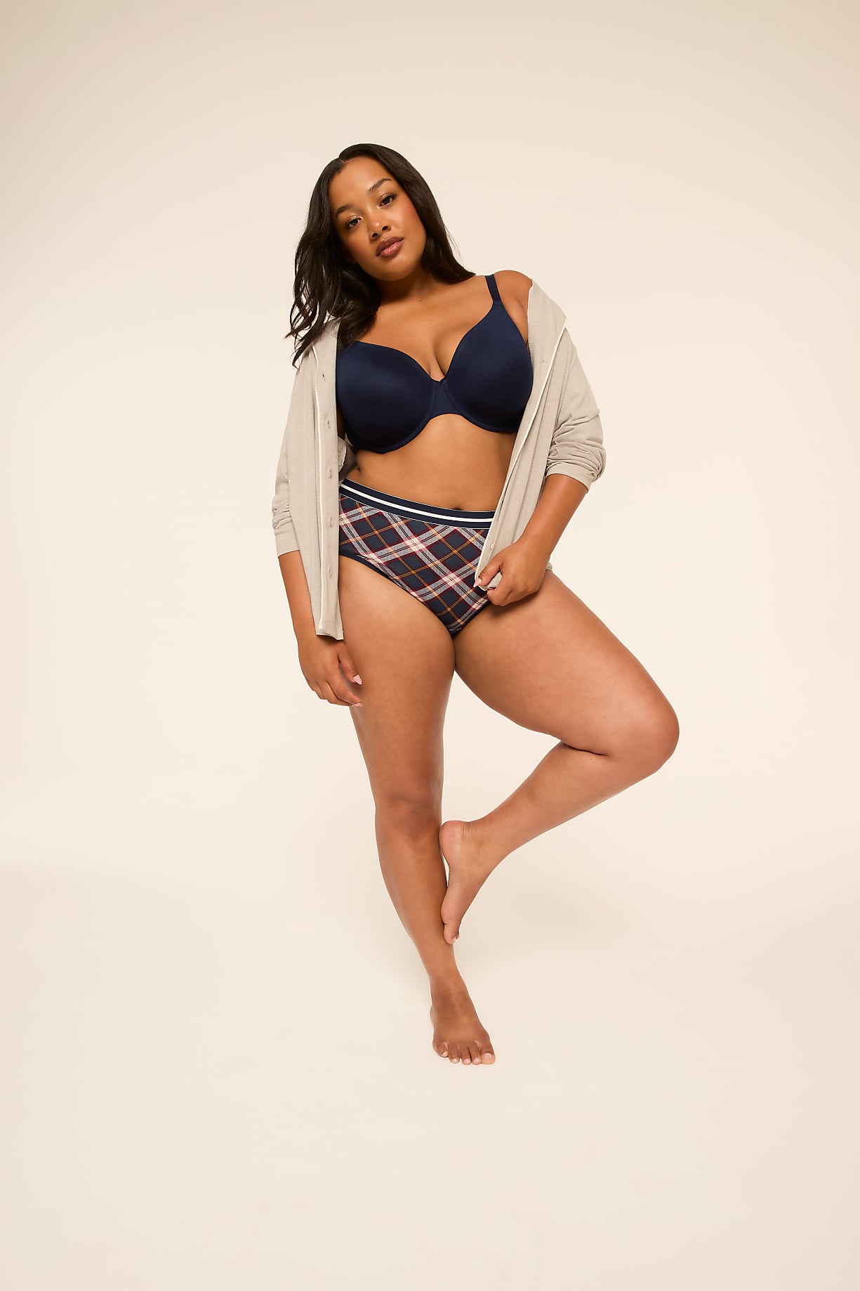 A woman in a navy bra and plaid underwear stands on one leg against a plain, light-colored background. Product Image 6