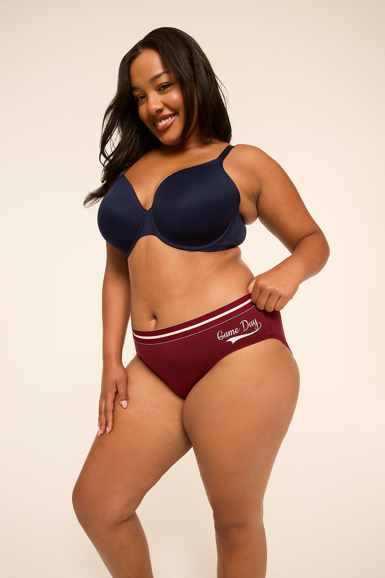 A smiling woman in a navy bra and maroon "Game Day" underwear stands against a plain, light background. Product Image 8