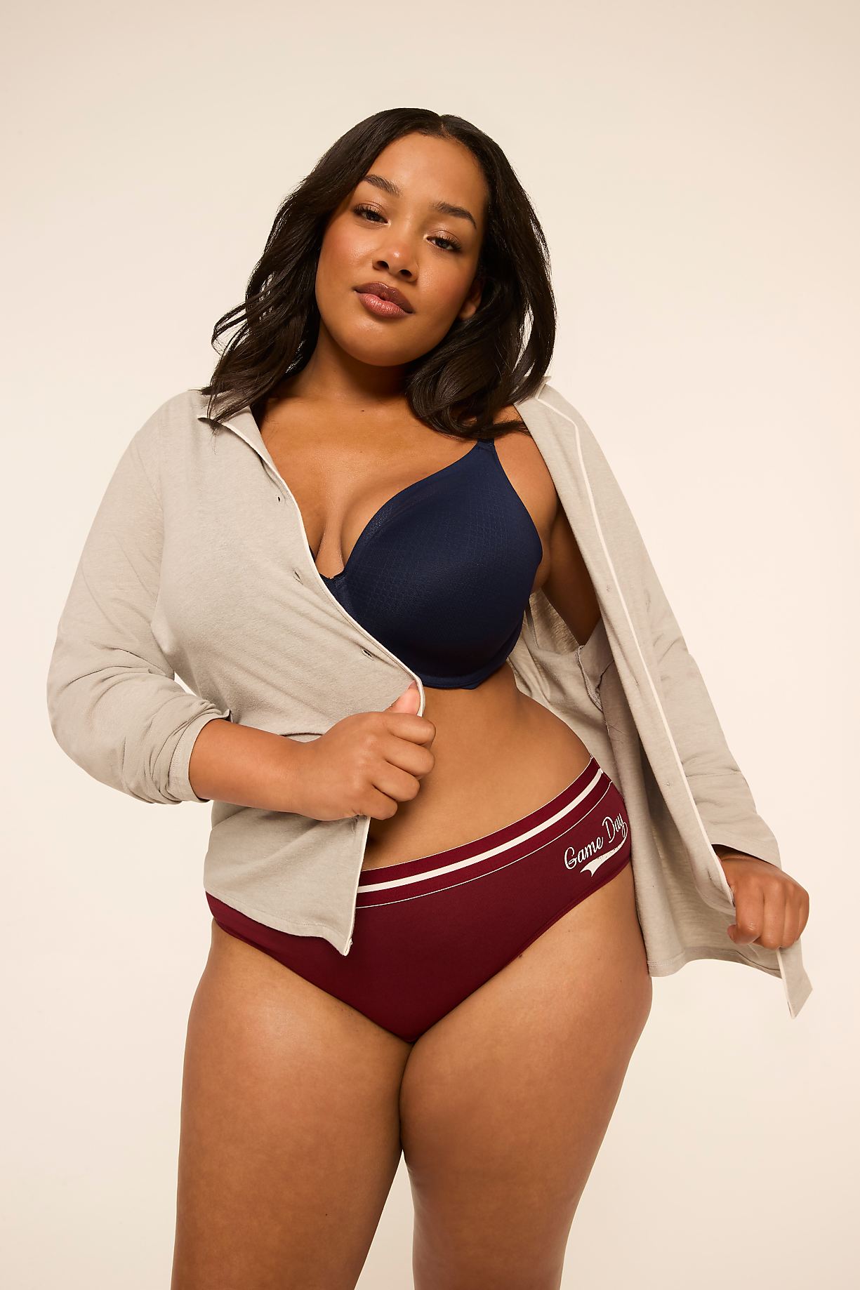 A woman in maroon underwear and a navy bra, with a light grey robe open, stands against a plain, light background. Product Image 9