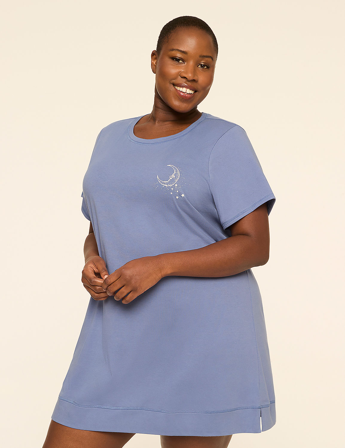 A smiling woman in a blue nightgown with a celestial design stands against a plain, light-colored background. Product Image 1