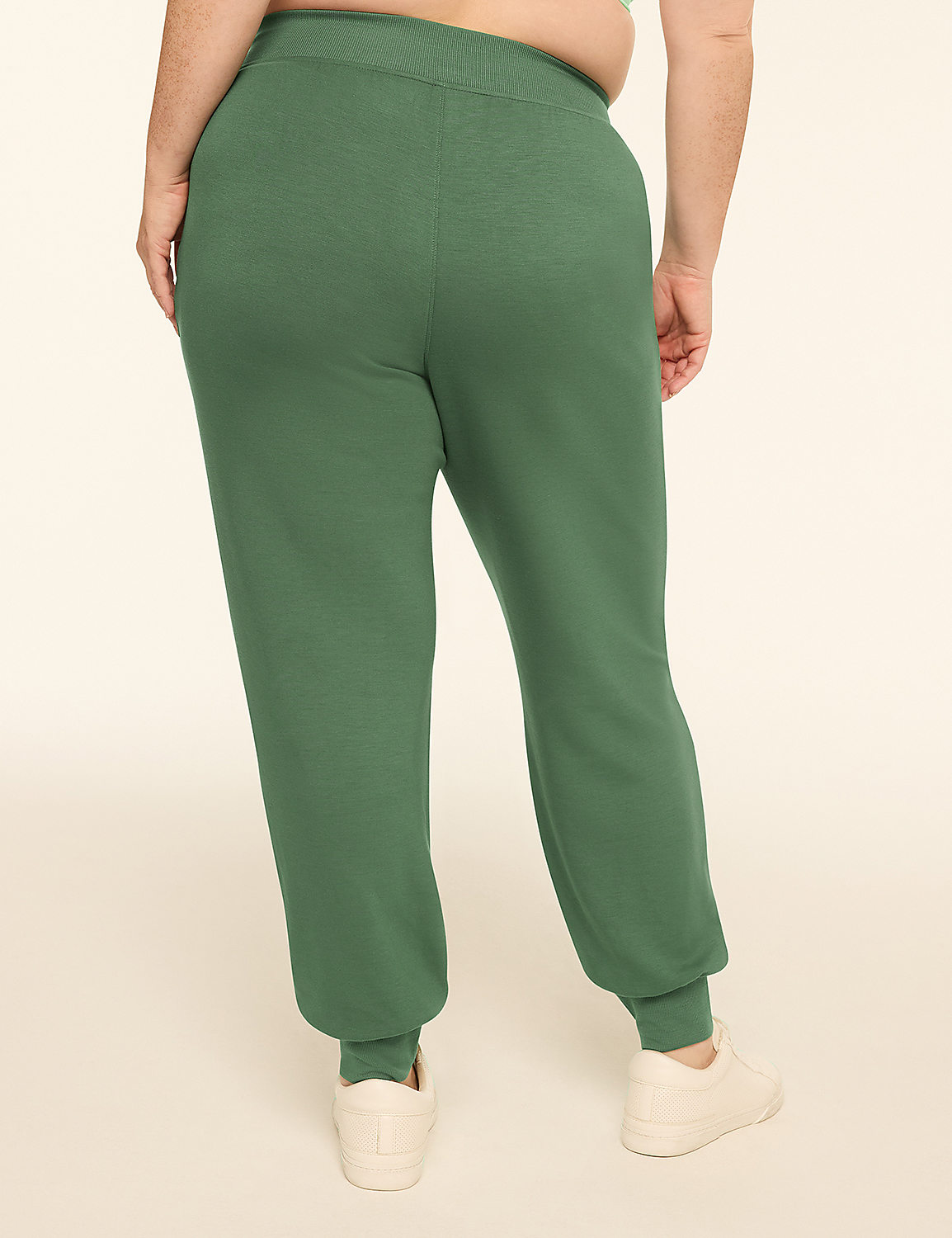 A person wearing green sweatpants and white sneakers stands against a plain, light-colored background. Product Image 2