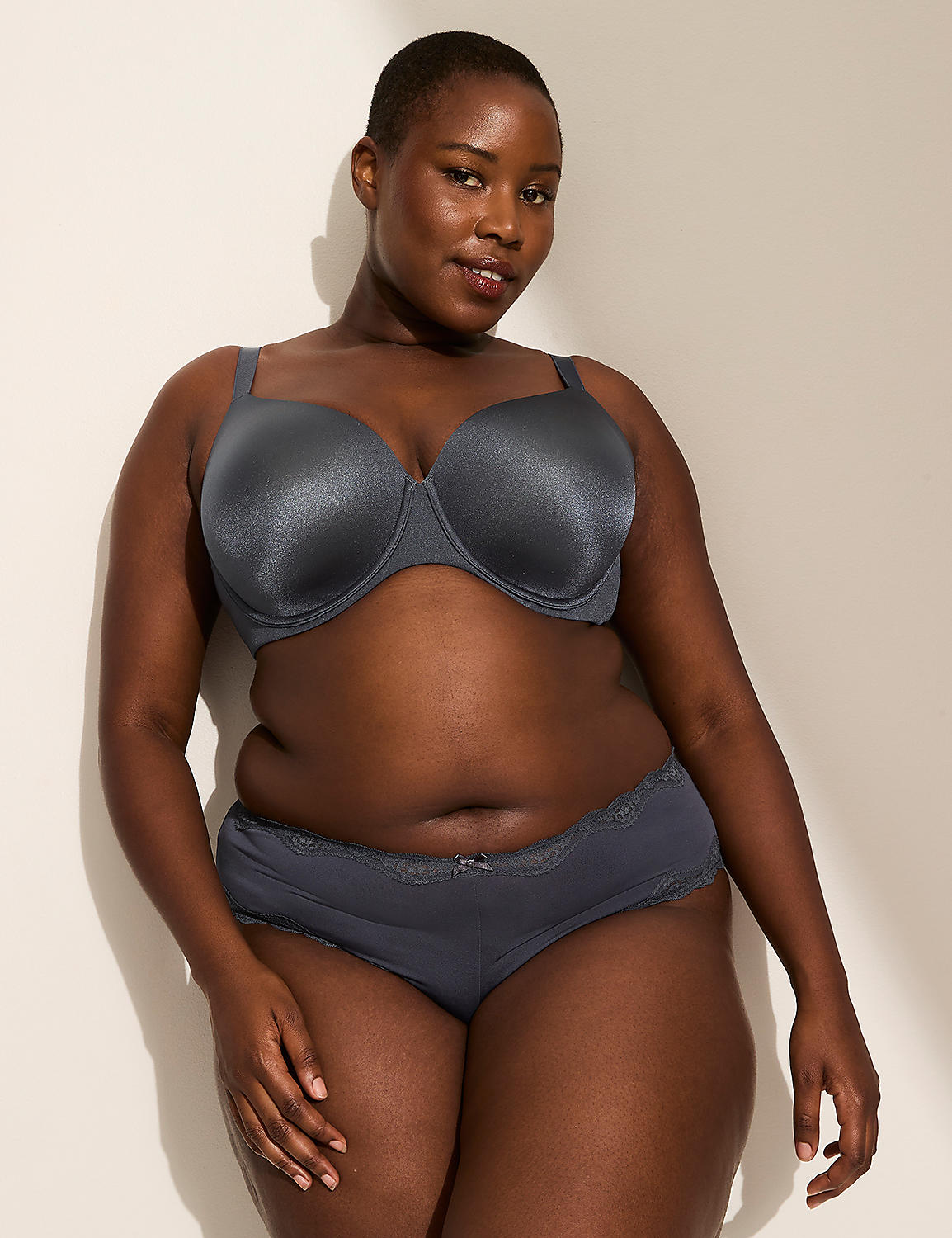 A person's lower body is shown from behind, wearing grey lace-trimmed underwear with the words "Good at being Bad" embroidered on the back, against a plain, light-colored background. Product Image 3