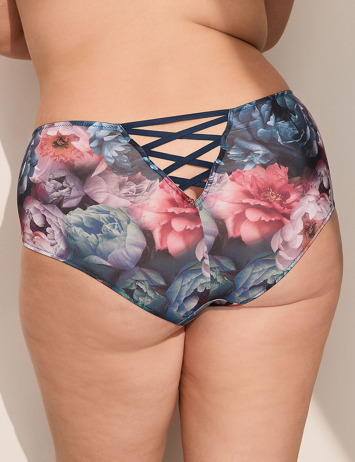 A close-up of a person's posterior is shown, wearing floral-patterned underwear with a criss-cross detail in the back, against a plain, light-colored background. Product Image 2