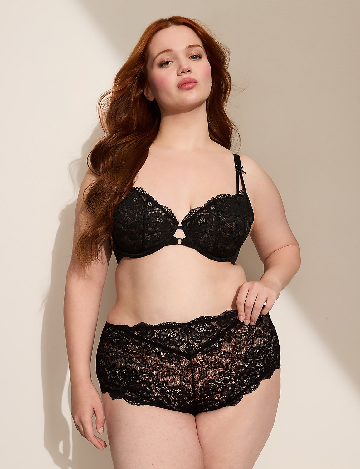 A person's lower body, clad in black lace-trimmed underwear, is shown against a plain, light-colored background. Product Image 3