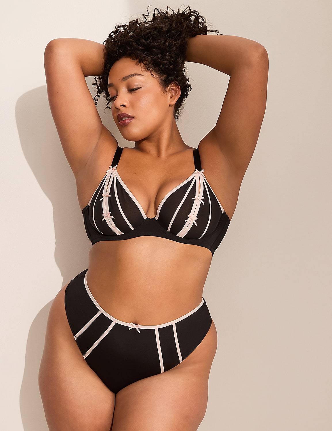 A close-up of a person's buttocks in black underwear with a light pink trim is set against a plain, light-colored background. Product Image 3