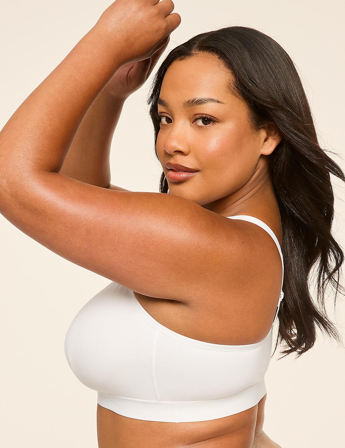A woman with dark hair and brown skin, wearing a white bra, poses with her arms raised against a plain, light-colored background. Product Image 4