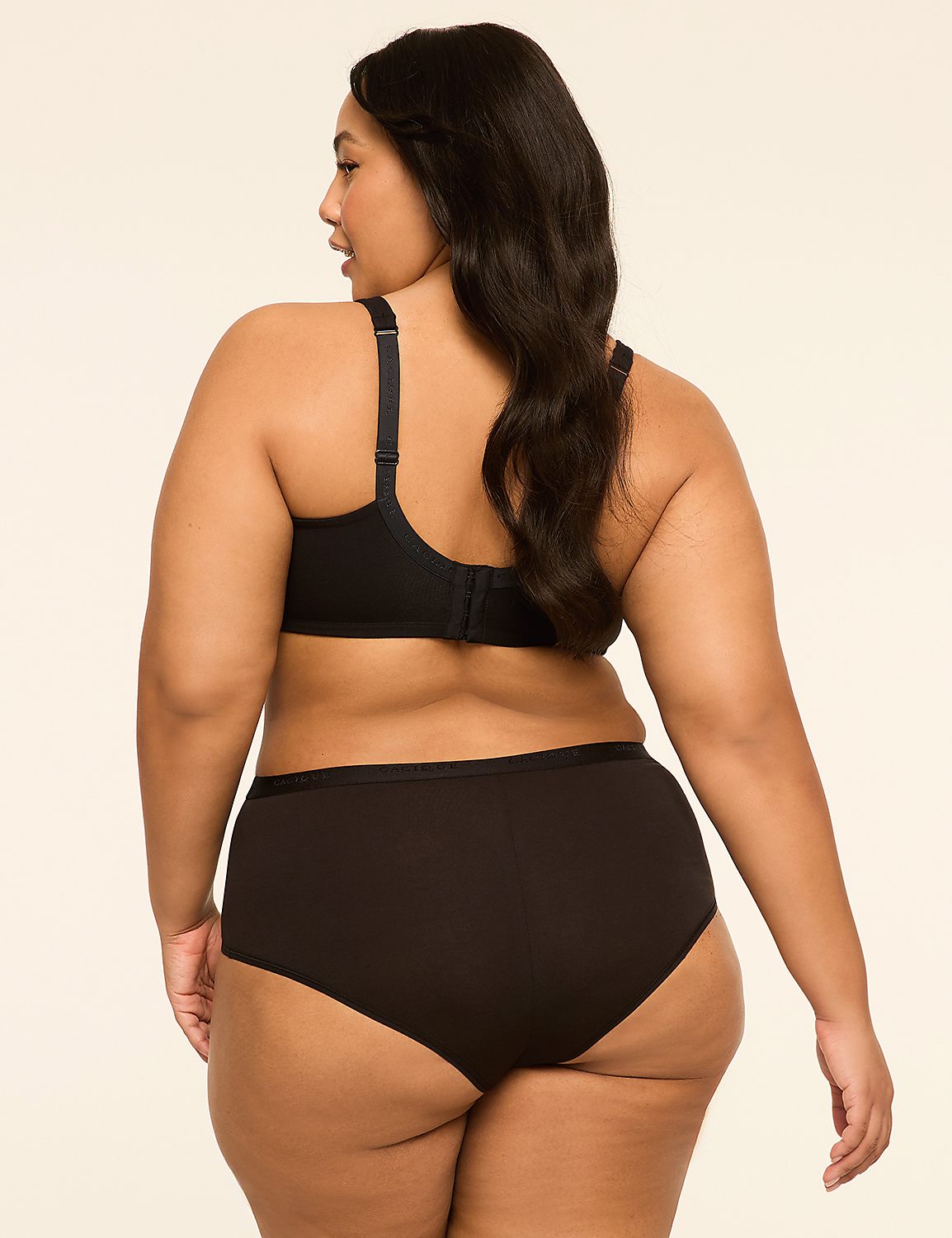 A woman in black lingerie stands against a plain, light-colored background. Product Image 2