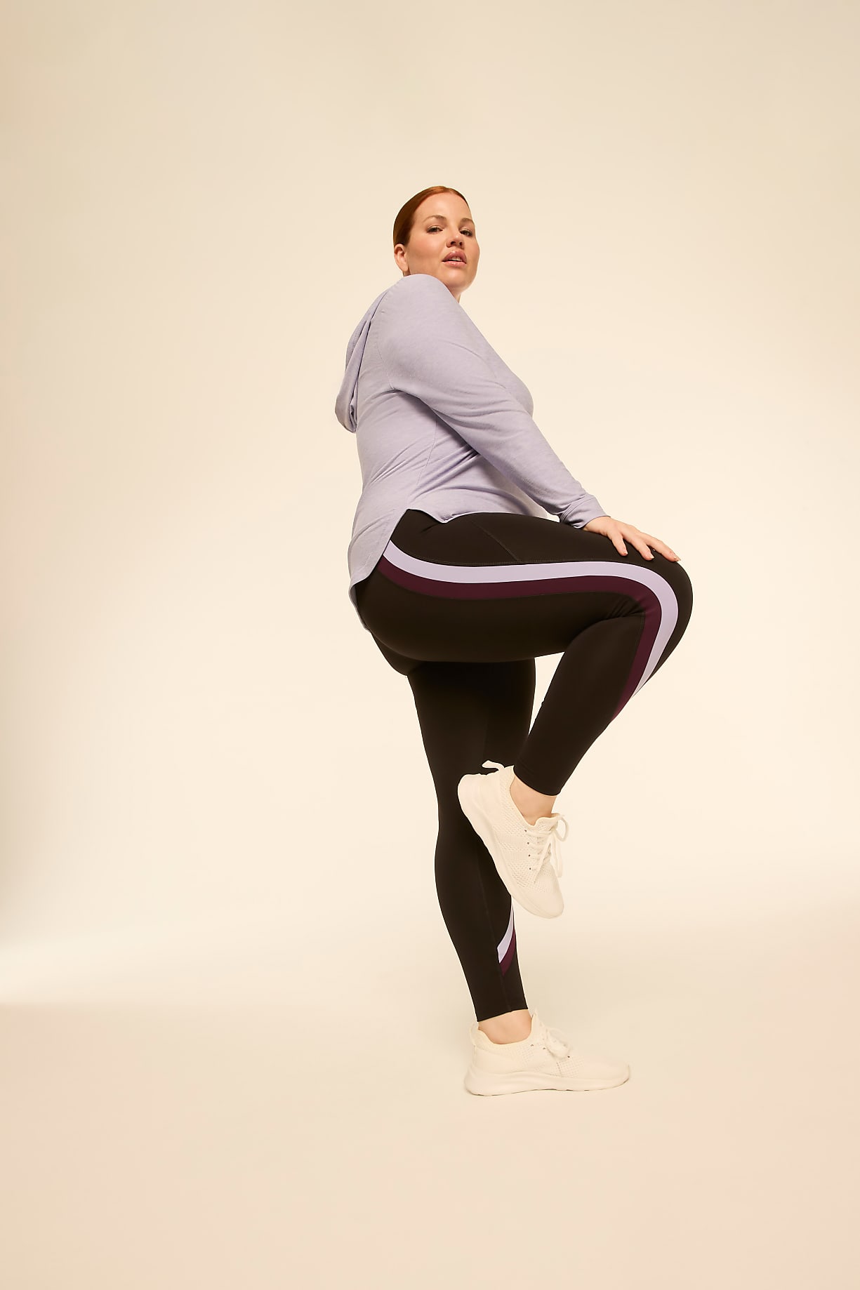 A woman in athletic wear poses against a plain, light-colored background. Product Image 4