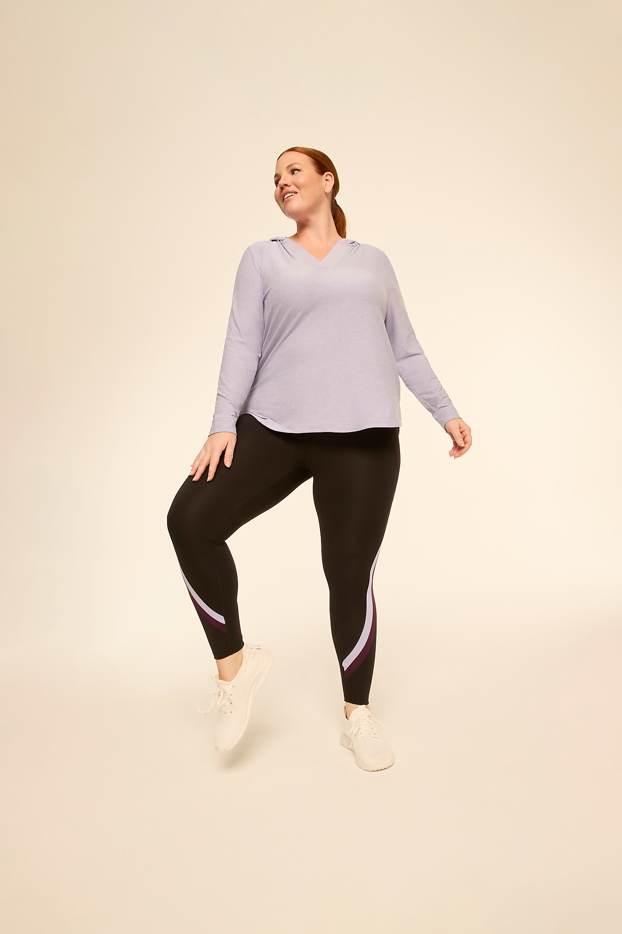 A woman in athletic wear poses against a plain, light-colored background. Product Image 6