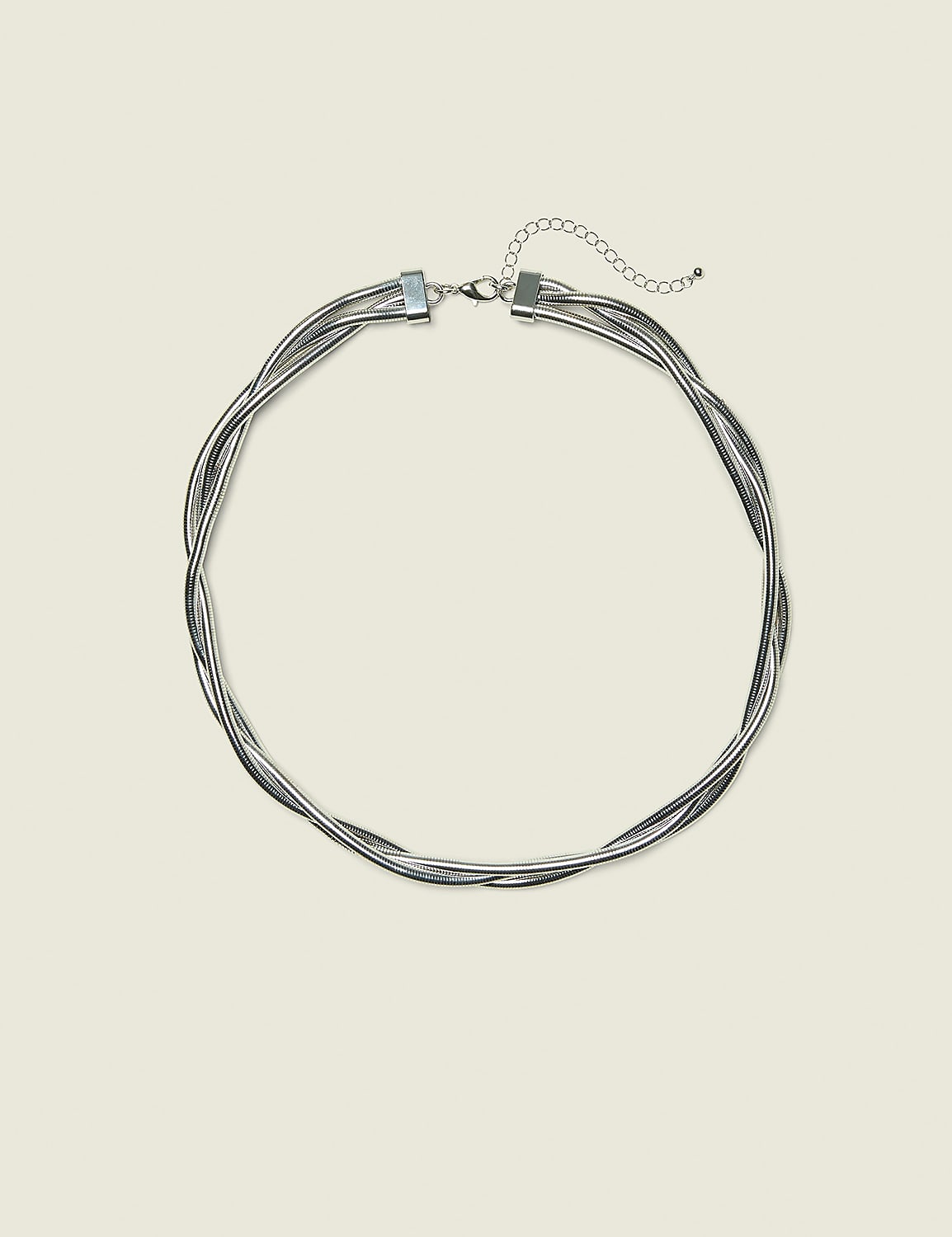A silver multi-strand twisted necklace with a clasp and extension chain rests on a pale yellow background. Product Image 1