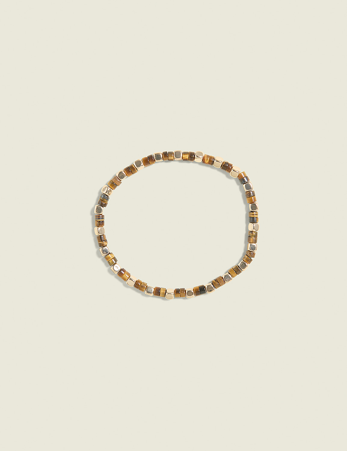 A beaded bracelet with tiger's eye and metallic beads rests on a pale beige background. Product Image 1