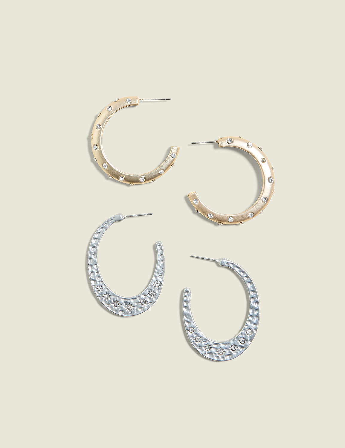 Two pairs of hoop earrings, one gold and one silver, are arranged on a pale yellow background. Product Image 1