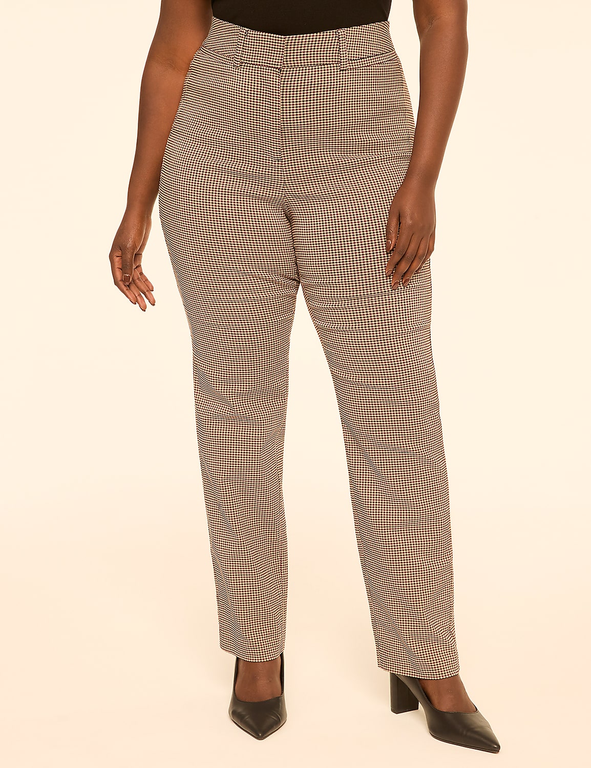 A person stands in the foreground wearing plaid pants and black heels against a plain, light-colored background. Product Image 1