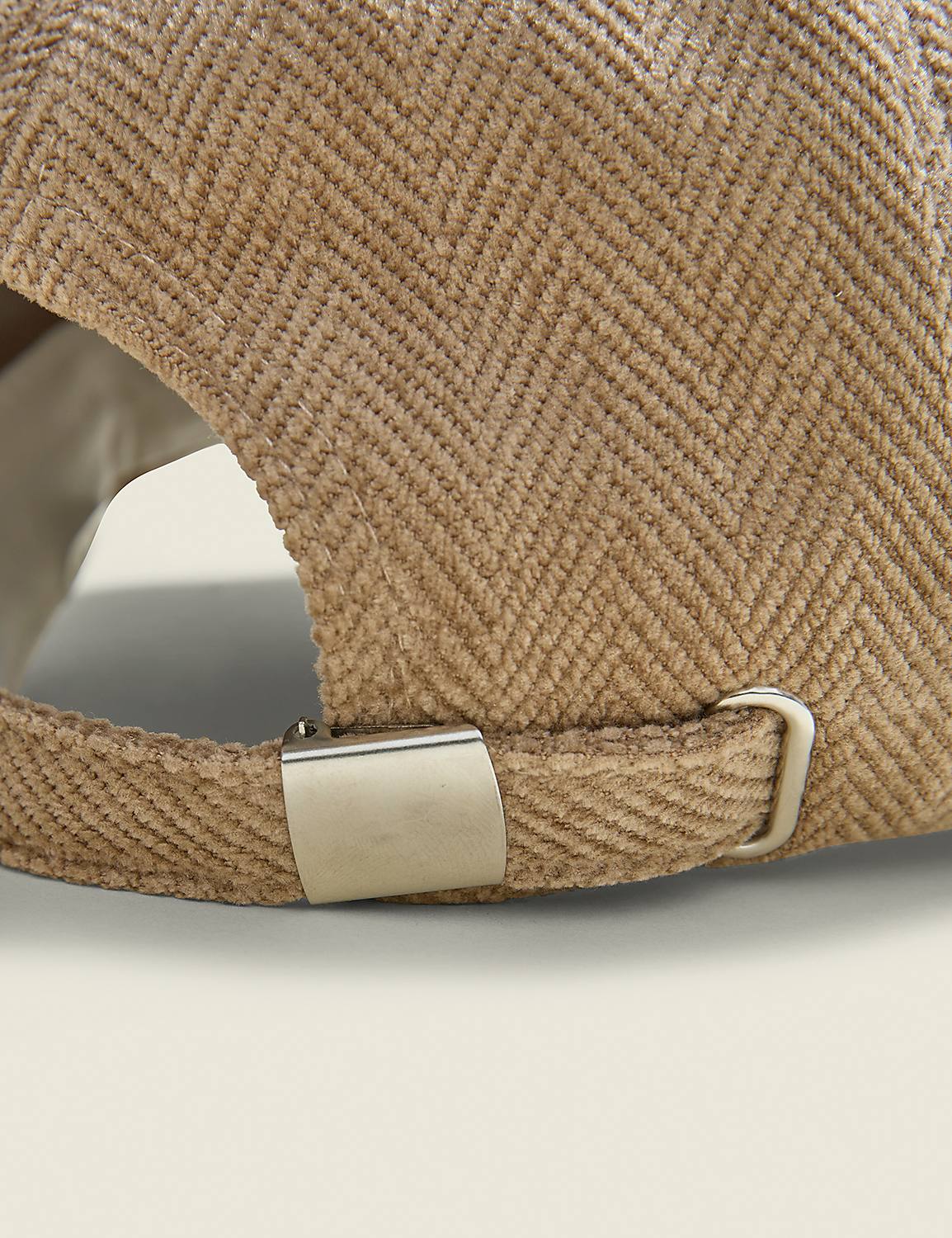 A close-up of the back of a tan herringbone baseball cap with a metal buckle is shown against a plain, light-colored background. Product Image 2