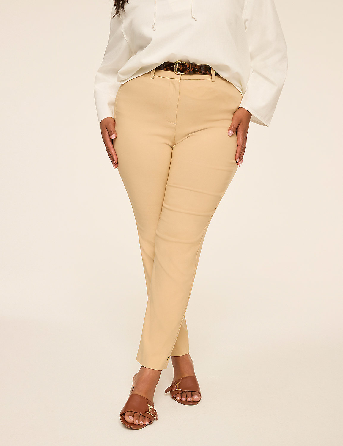 A woman in a white blouse and tan pants stands against a plain, light background. Product Image 9