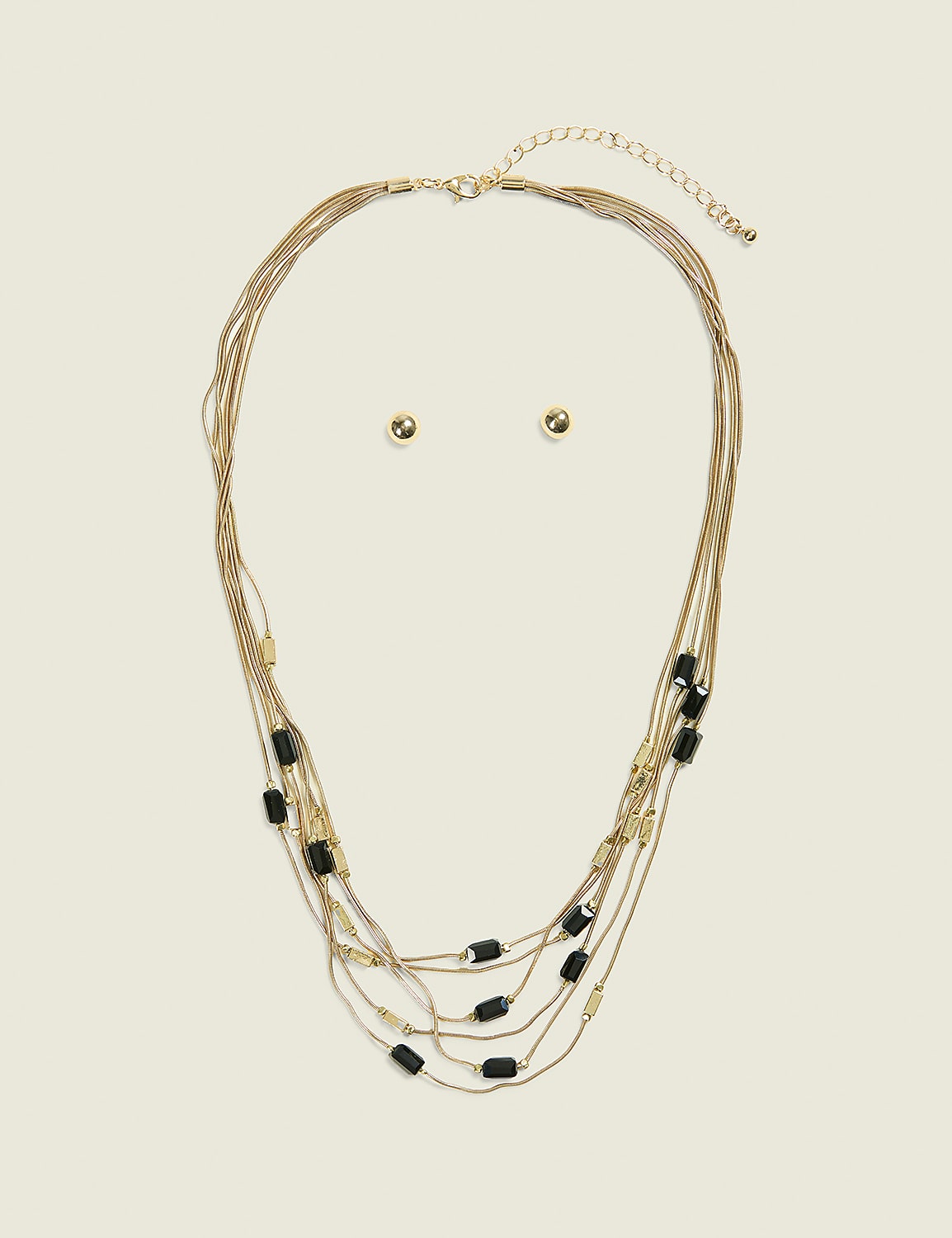 A layered gold necklace with black beads and matching stud earrings are displayed against a plain, light beige background. Product Image 1