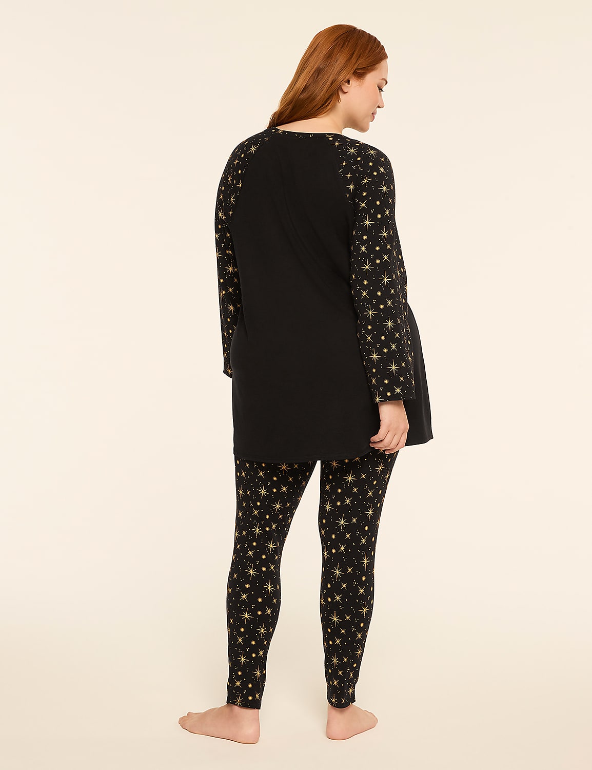 A woman in a black star-patterned pajama set stands against a plain, light-colored background. Product Image 2