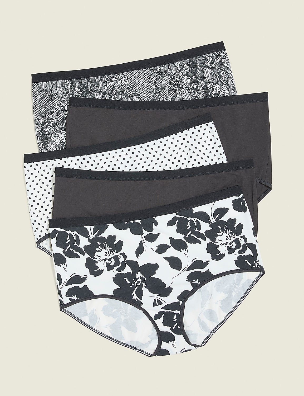 Four pairs of patterned underwear are stacked in the foreground against a plain, light-colored background. Product Image 1