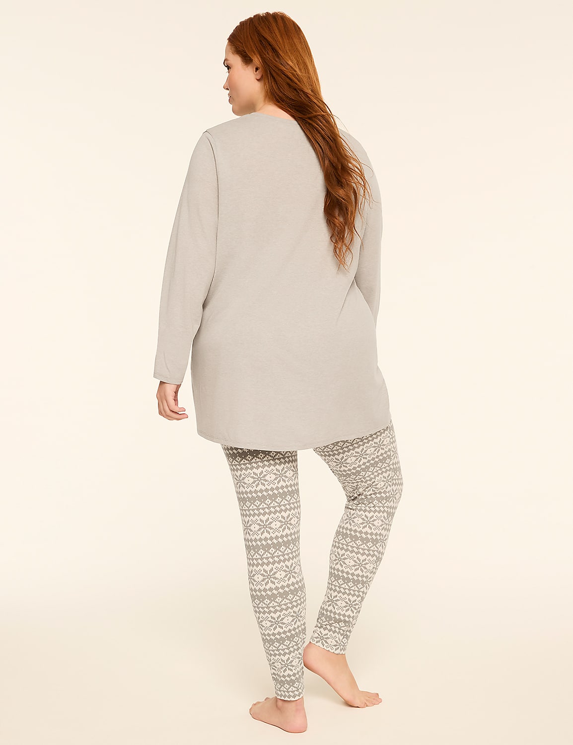 A woman with long red hair stands facing away from the camera, wearing a grey long-sleeved top and patterned leggings against a plain, light background. Product Image 2