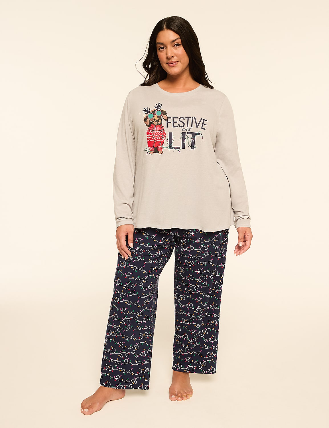A woman stands in festive pajamas with a graphic on her shirt, against a plain, light-colored background. Product Image 1