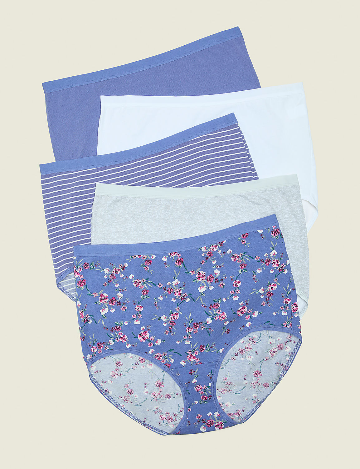 A stack of five women's underwear, with the bottom pair featuring a floral pattern, are arranged against a plain, light brown background. Product Image 1