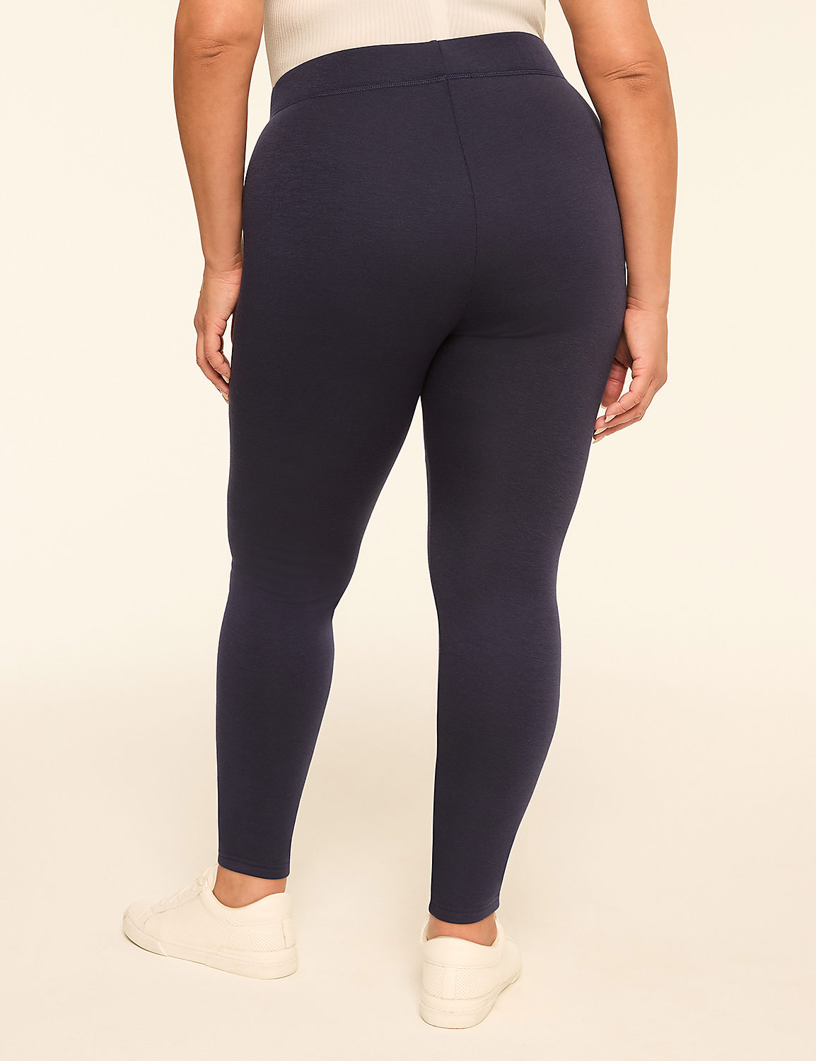 A person wearing navy blue leggings and white sneakers stands against a plain, light-colored background. Product Image 2