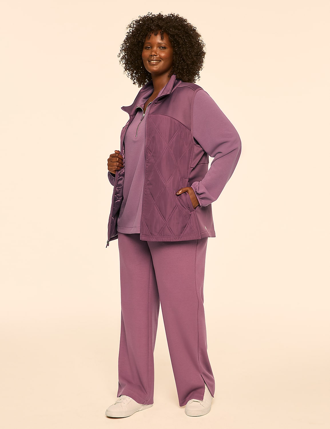 A woman in a pink tracksuit stands against a plain, light-colored background. Product Image 3
