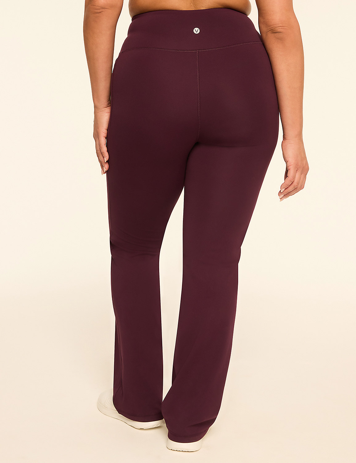A person wearing maroon bootcut yoga pants stands against a plain, light-colored background. Product Image 2