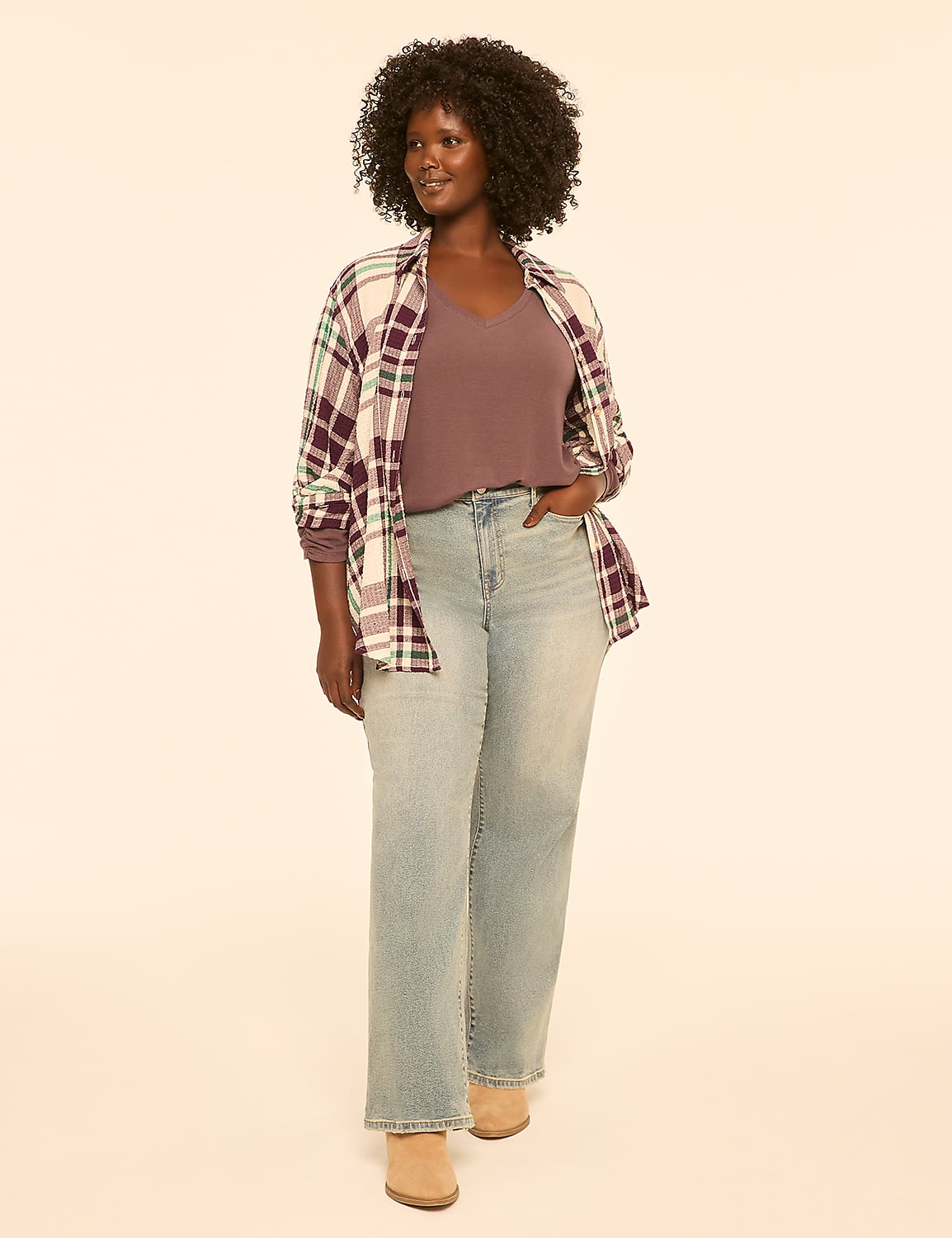 A woman in a purple top, plaid shirt, and light wash jeans stands against a plain, light background. Product Image 3