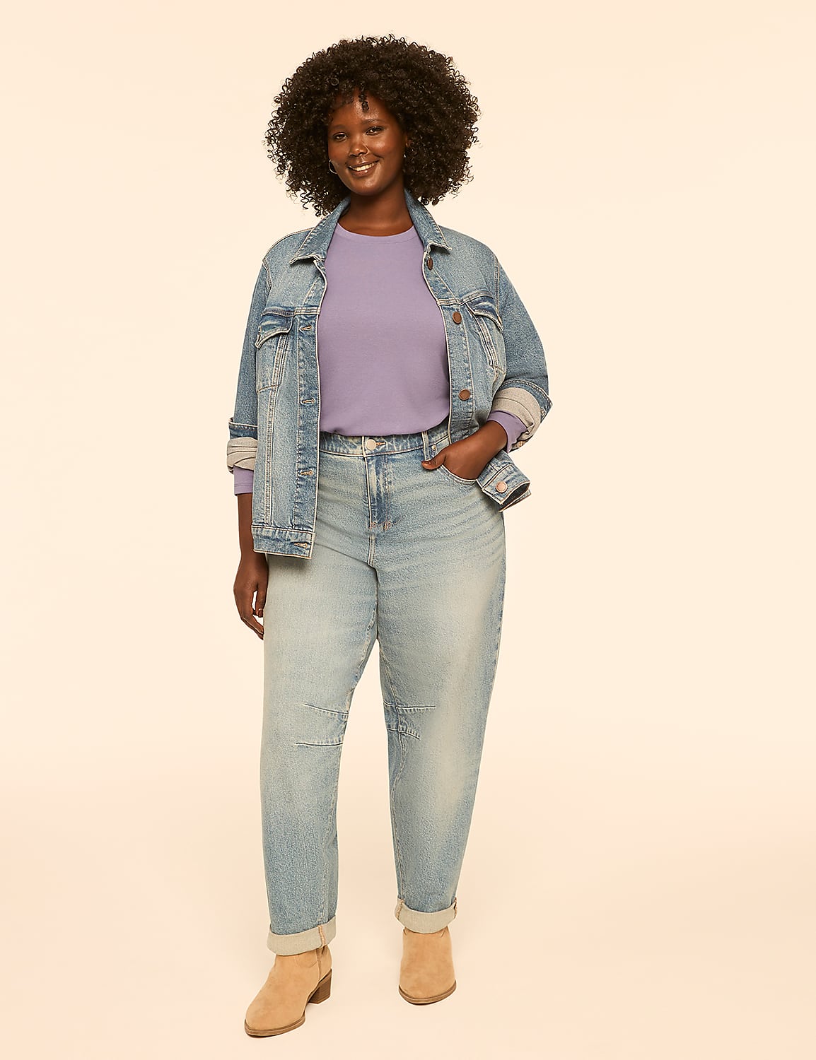 A smiling woman in a denim jacket and light wash jeans stands against a plain, light-colored background. Product Image 3