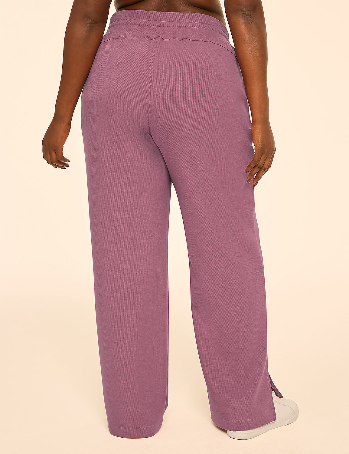 A person wearing pink ribbed wide-leg pants stands against a plain cream background. Product Image 2
