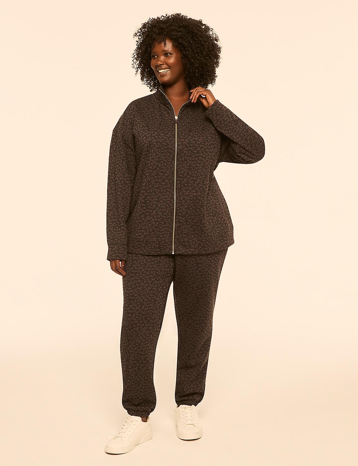 A smiling woman in a leopard-print tracksuit stands against a plain, light-colored background. Product Image 3