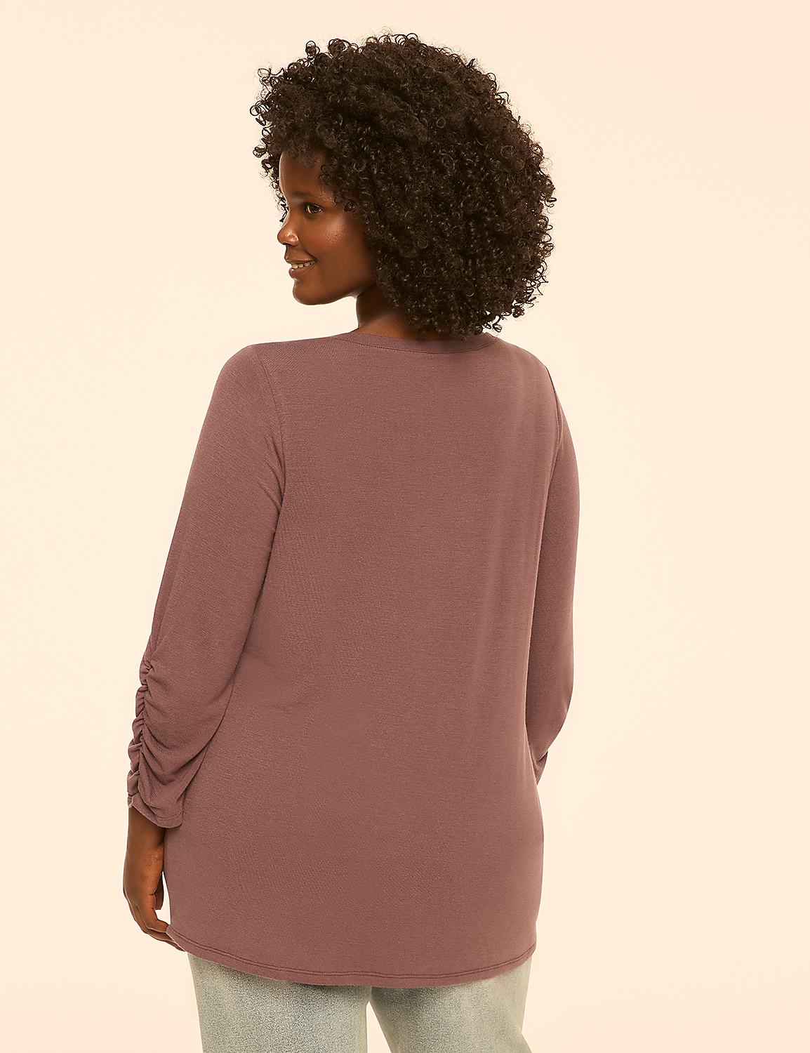A woman with curly dark hair, wearing a mauve long-sleeved shirt, is shown from the back against a plain, light peach background. Product Image 2