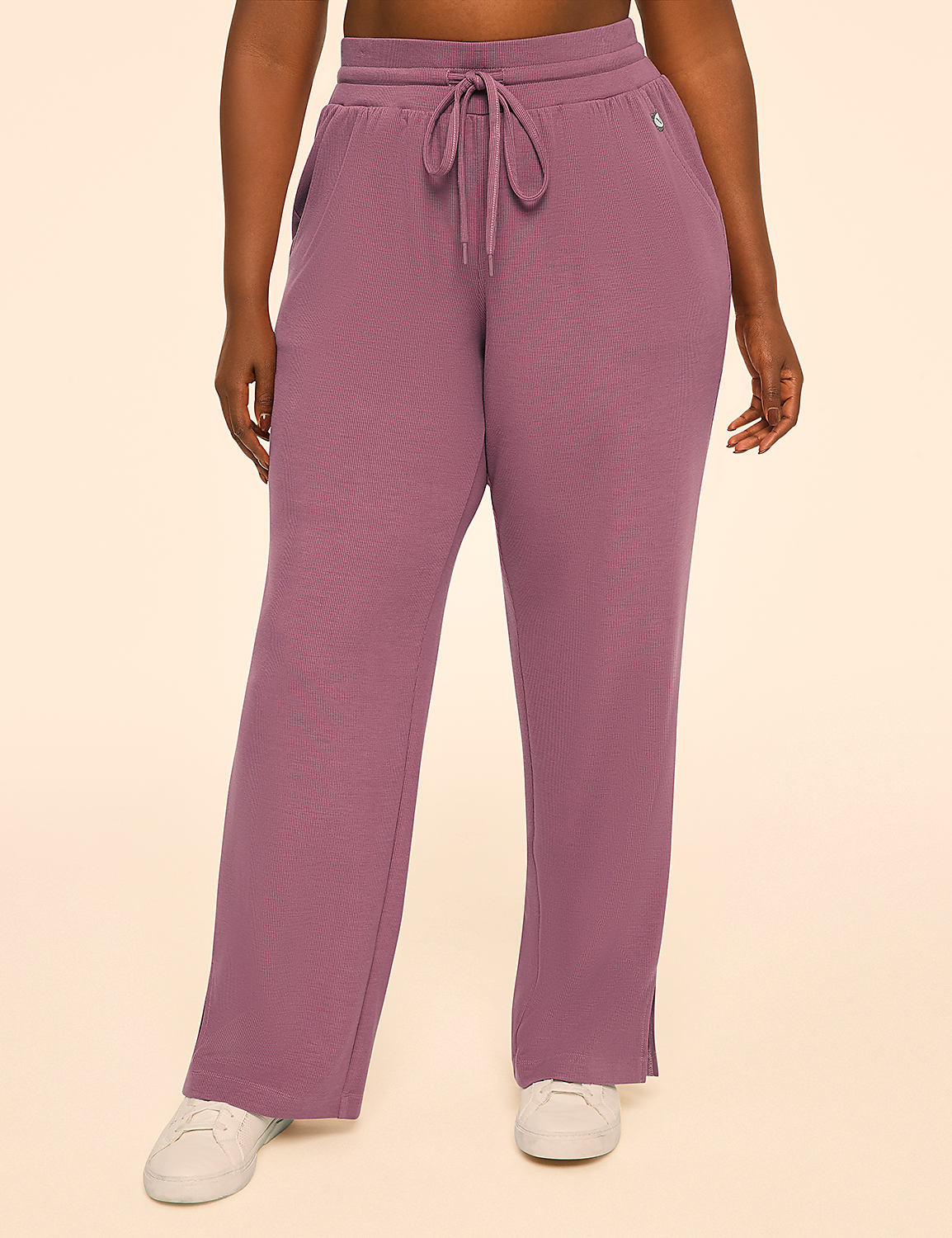 A person wearing rose-colored sweatpants with white sneakers stands against a plain, light-colored background. Product Image 1