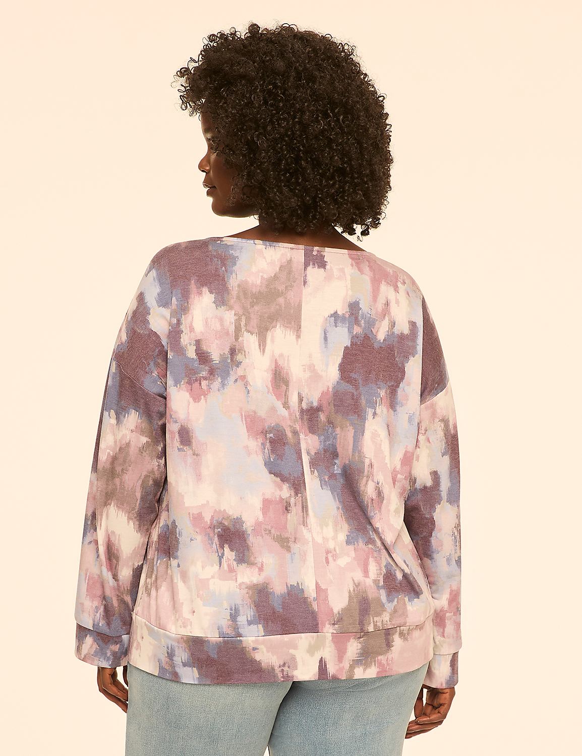 A woman wearing a colorful, abstract-patterned sweatshirt is shown from the back against a plain, light-colored background. Product Image 2