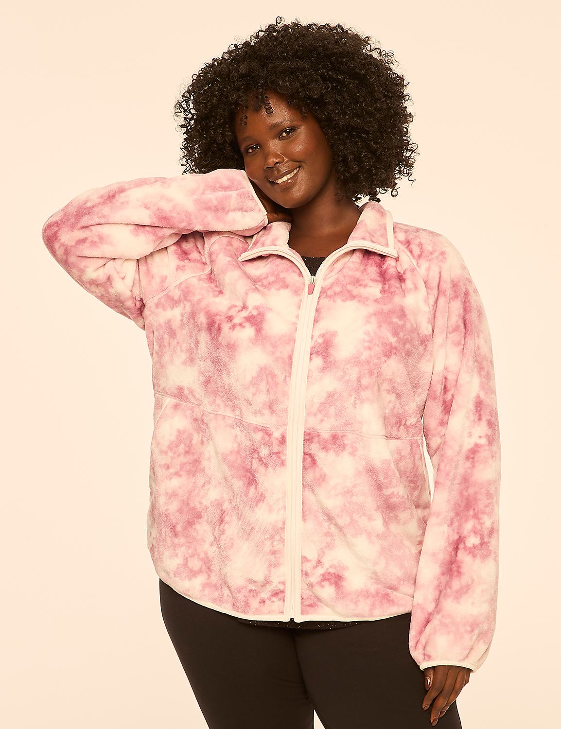 A smiling woman with dark curly hair poses in a pink tie-dye jacket against a plain, light-colored background. Product Image 1