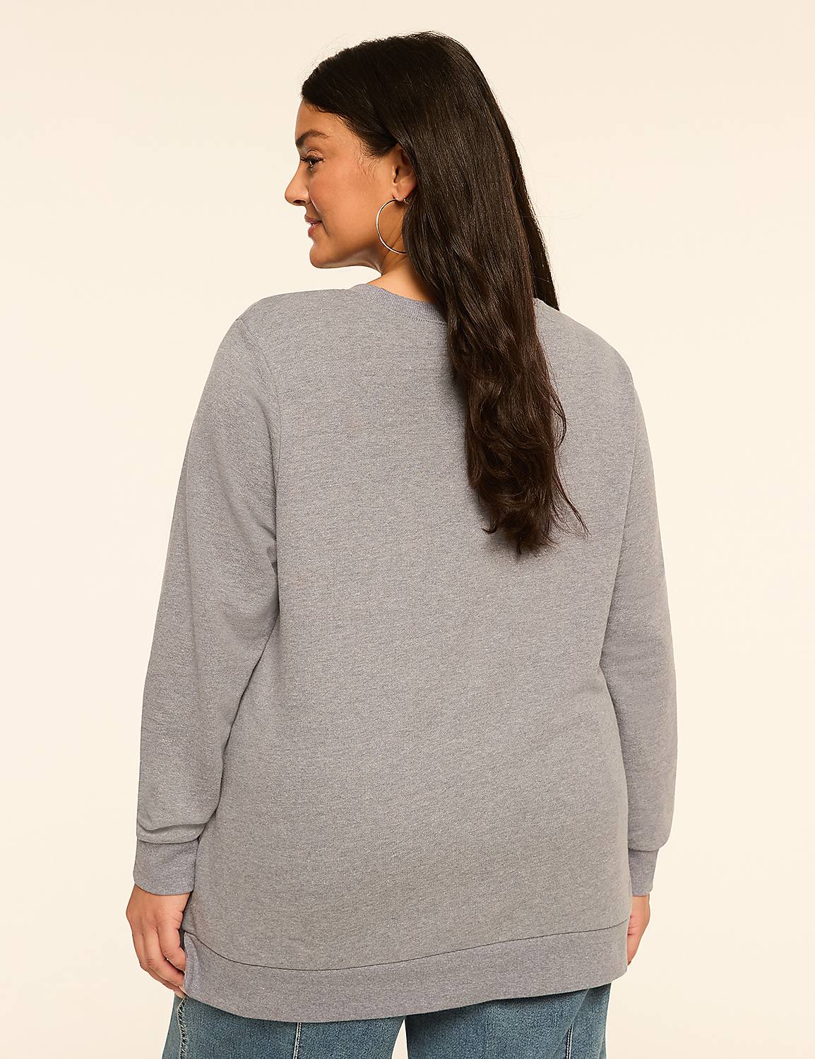 A woman in a gray sweatshirt stands against a plain, light-colored background. Product Image 2
