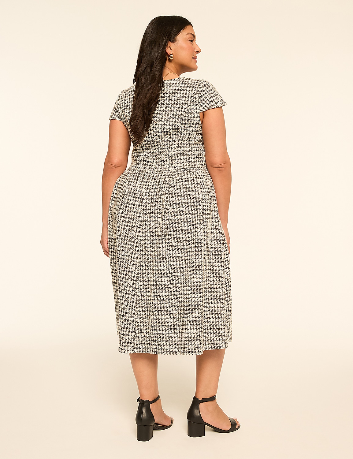 A woman in a patterned dress stands against a plain, light-colored background. Product Image 2