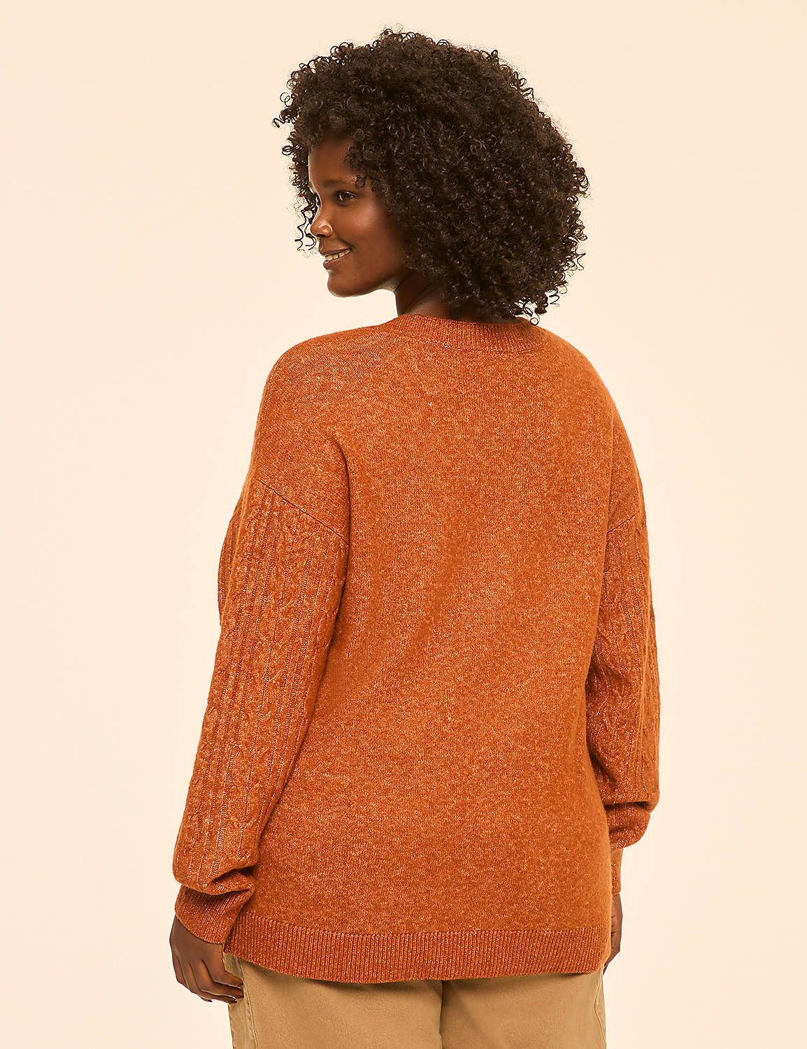 A woman in a rust-colored sweater is shown from the back against a plain, light peach background. Product Image 2