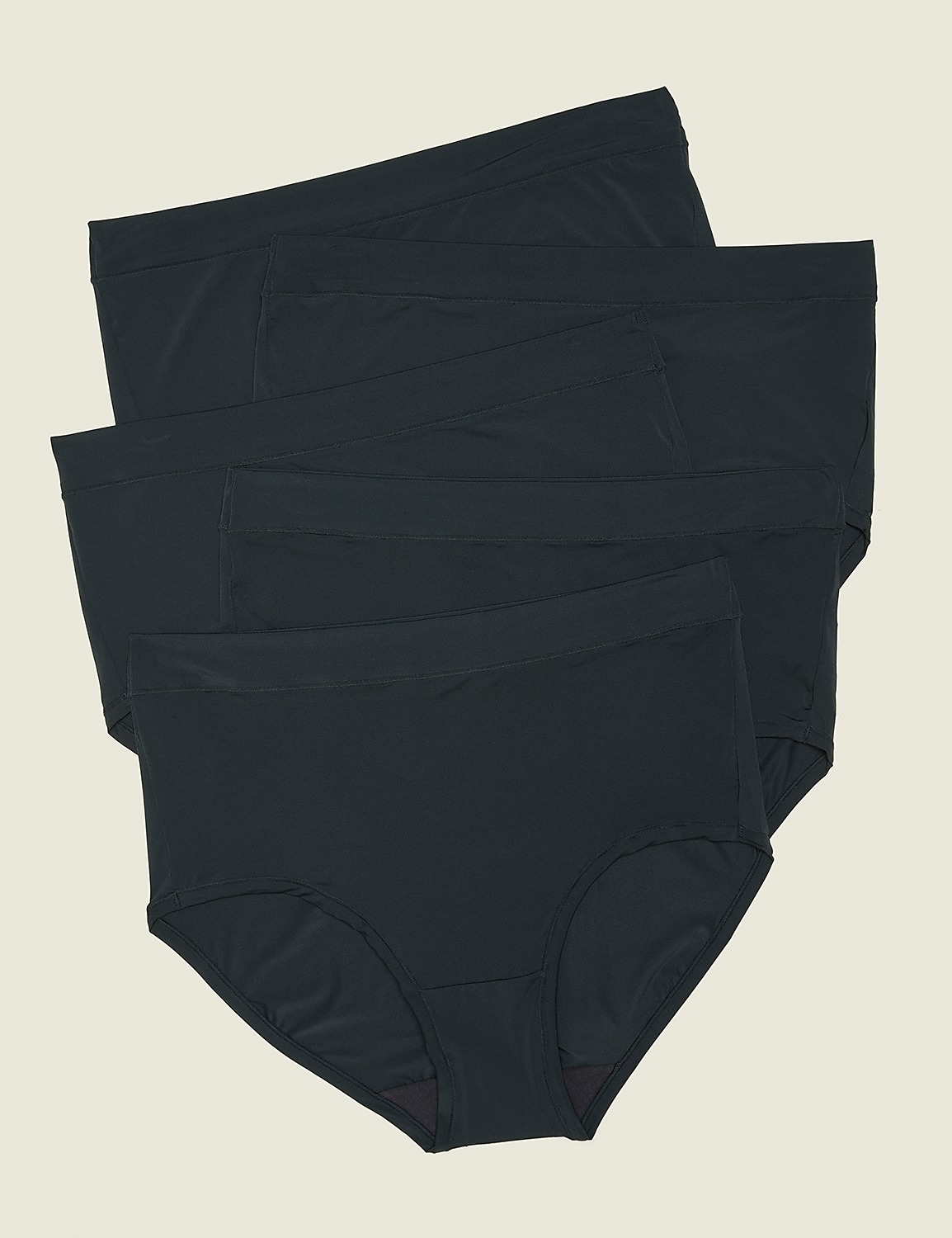 Three dark grey briefs are stacked in the foreground against a plain, light beige background. Product Image 1