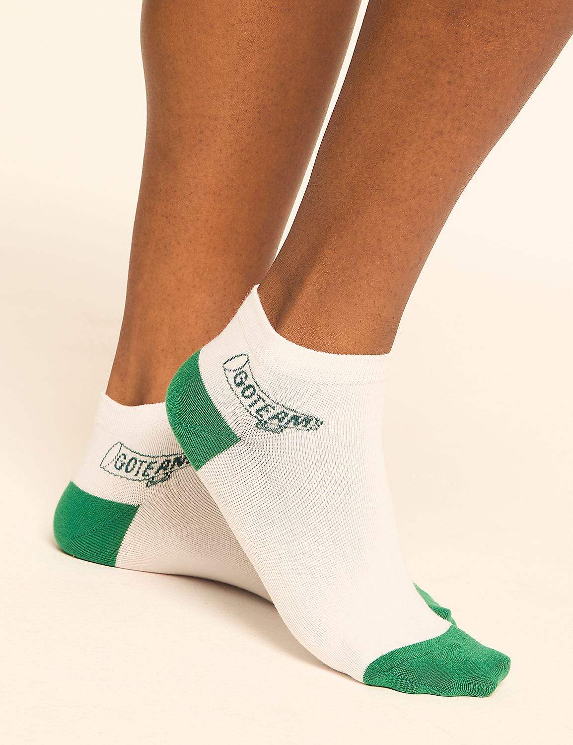 White ankle socks with green accents and a "GOTERM" logo are worn on a person's feet against a plain, light-colored background. Product Image 2