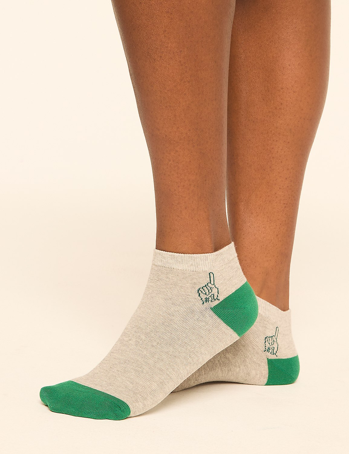 Light gray ankle socks with green toes and heels, featuring a small embroidered hand gesture, are worn by a person against a plain, light-colored background. Product Image 3