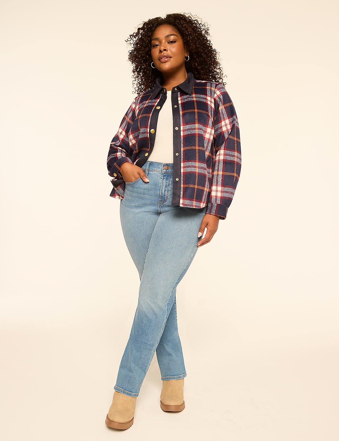 A smiling woman in a plaid jacket, navy top, and jeans stands against a plain, light-colored background. Product Image 3