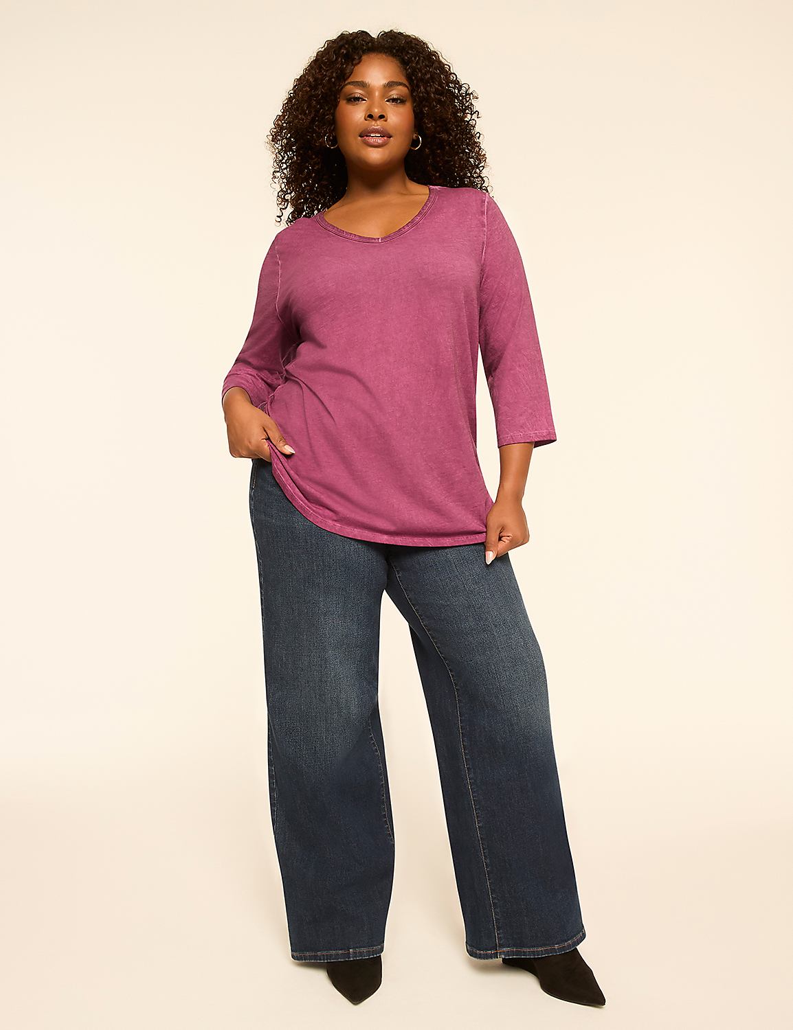 A woman in a purple top and wide-leg jeans stands against a plain, light-colored background. Product Image 3